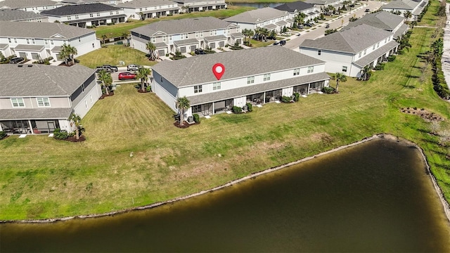 drone / aerial view with a residential view and a water view