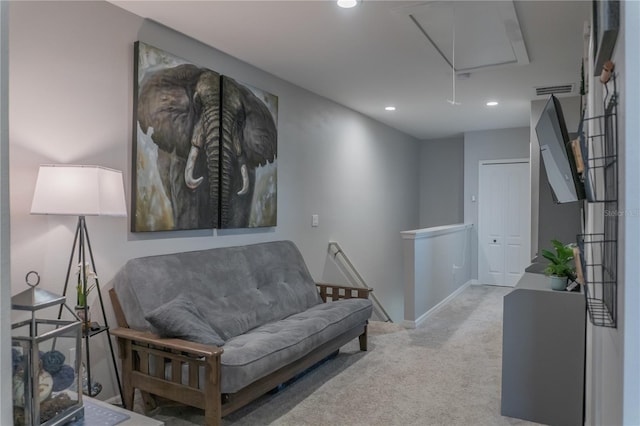 living area with recessed lighting, light carpet, an upstairs landing, baseboards, and attic access