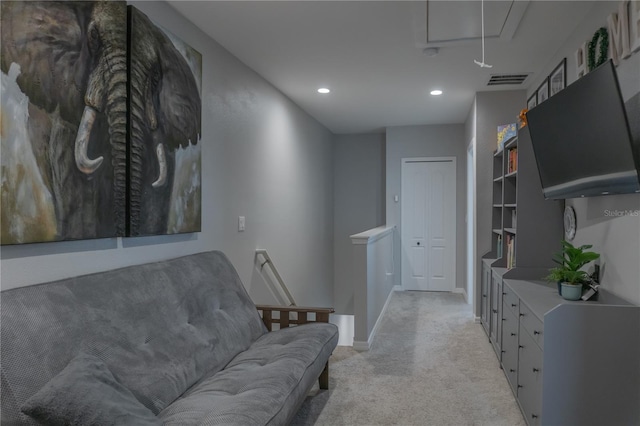 living area featuring attic access, baseboards, light colored carpet, an upstairs landing, and recessed lighting