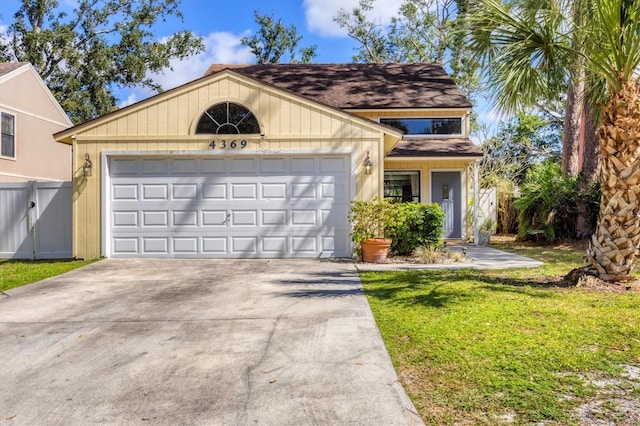 view of front of home with a garage, driveway, and a front yard