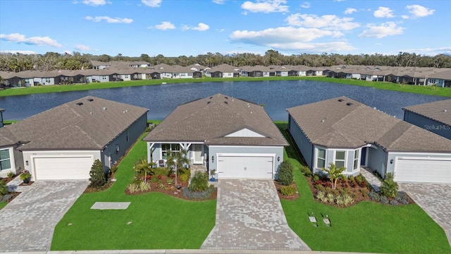 drone / aerial view with a residential view and a water view