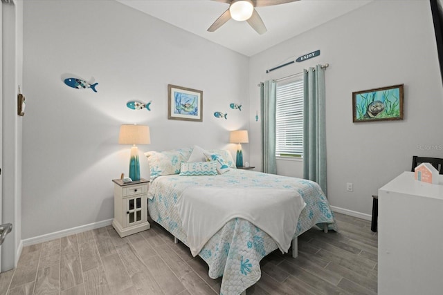 bedroom with ceiling fan, wood finished floors, and baseboards