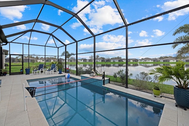 pool featuring a water view, glass enclosure, a patio area, and a residential view