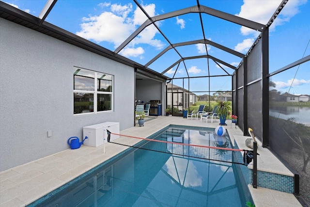 outdoor pool featuring a grill, a lanai, a water view, and a patio