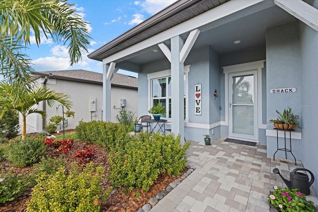 property entrance with stucco siding