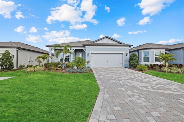 ranch-style home featuring a garage, a front lawn, decorative driveway, and stucco siding