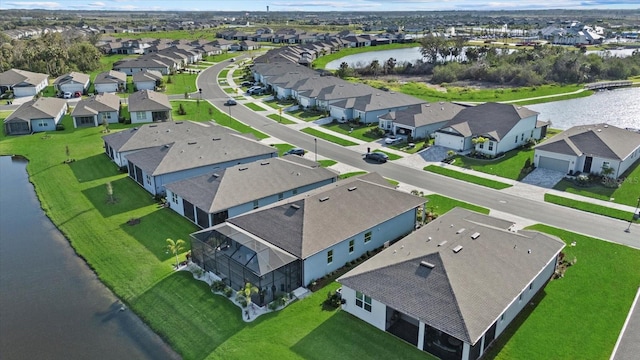 birds eye view of property featuring a water view and a residential view