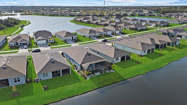 drone / aerial view with a water view and a residential view