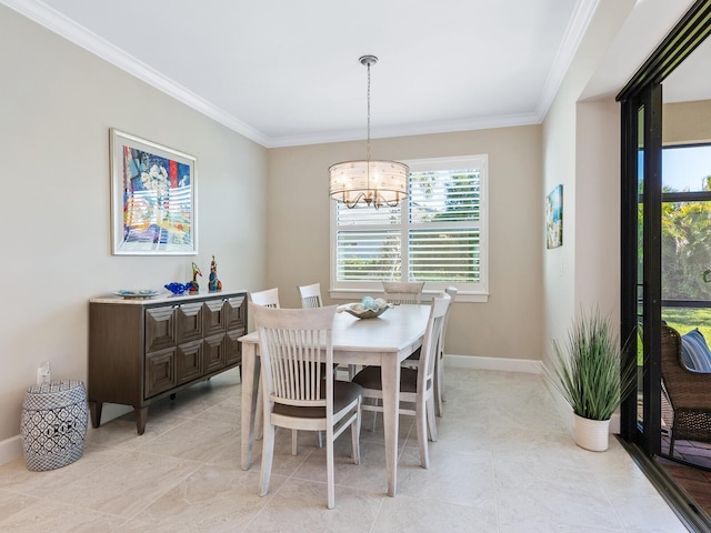 dining room featuring crown molding and baseboards