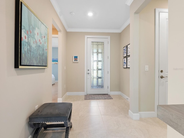 foyer featuring baseboards, ornamental molding, and light tile patterned flooring