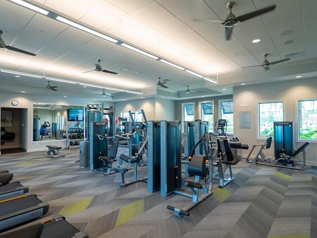 gym with a ceiling fan, carpet flooring, visible vents, and baseboards