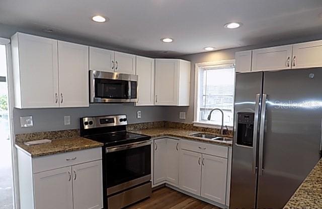 kitchen featuring white cabinetry, appliances with stainless steel finishes, and sink