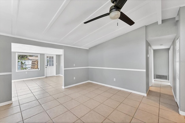 spare room featuring light tile patterned floors, visible vents, lofted ceiling with beams, ceiling fan, and baseboards