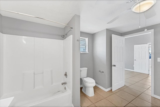 full bath featuring toilet, baseboards, shower / washtub combination, and tile patterned floors