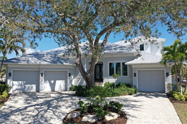 view of front of property featuring decorative driveway and a garage