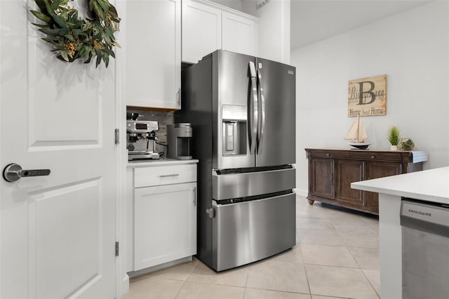 kitchen featuring appliances with stainless steel finishes, white cabinets, light countertops, and light tile patterned flooring