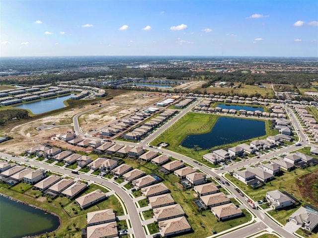 birds eye view of property with a residential view and a water view