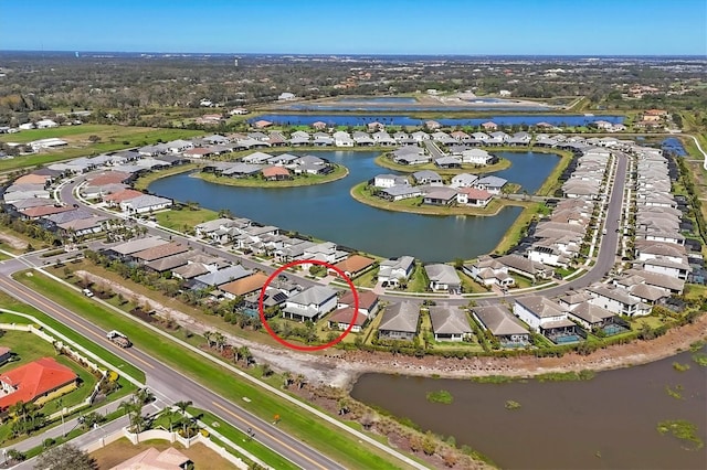 birds eye view of property with a residential view and a water view