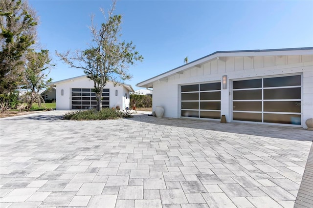 garage with decorative driveway