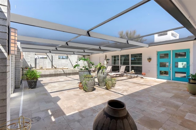 view of patio with glass enclosure