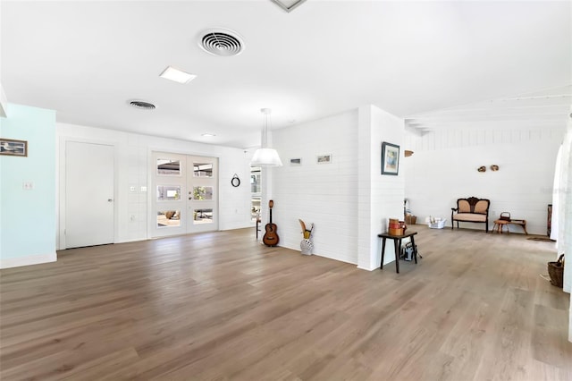 interior space with wood finished floors and visible vents