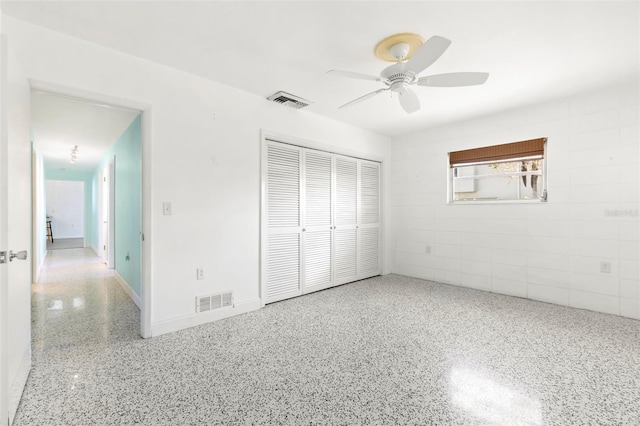 unfurnished bedroom featuring ceiling fan, visible vents, a closet, and speckled floor