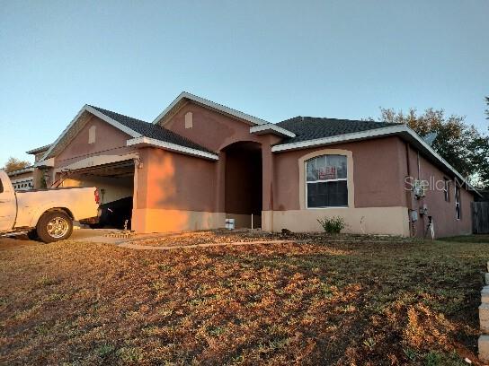 view of front of home featuring an attached garage and stucco siding