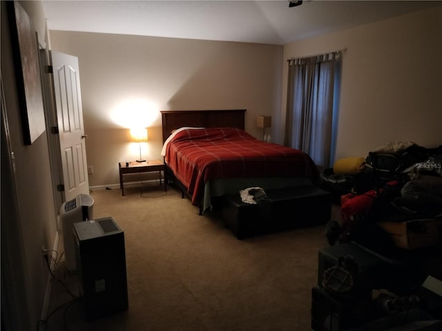 bedroom featuring carpet floors and lofted ceiling