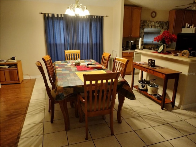 dining space with light tile patterned floors and a notable chandelier