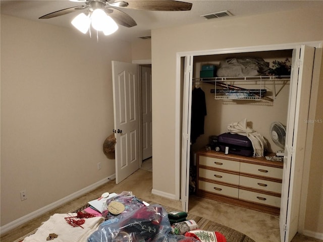 bedroom with ceiling fan, light carpet, visible vents, baseboards, and a closet