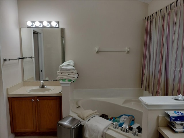 bathroom featuring a garden tub and vanity