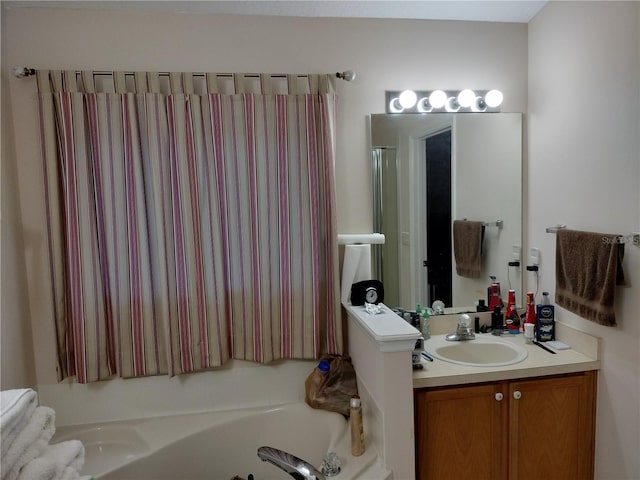 bathroom featuring vanity and a bath