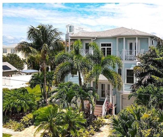 view of front of home featuring french doors and a balcony