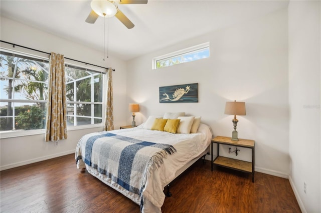 bedroom with dark wood-style flooring, ceiling fan, and baseboards