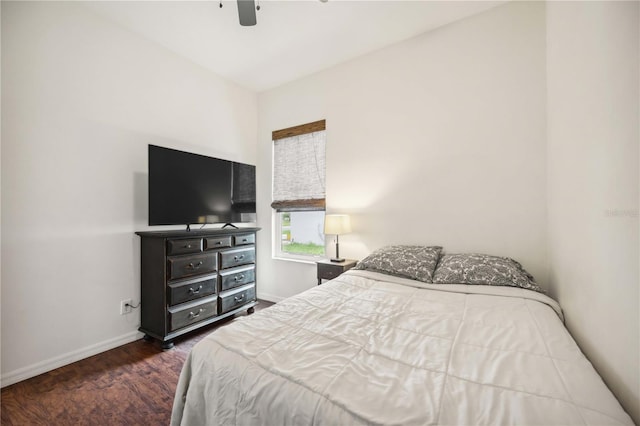 bedroom with a ceiling fan, dark wood-style flooring, and baseboards