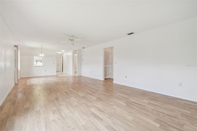 unfurnished living room featuring visible vents, ceiling fan, light wood-style flooring, and baseboards