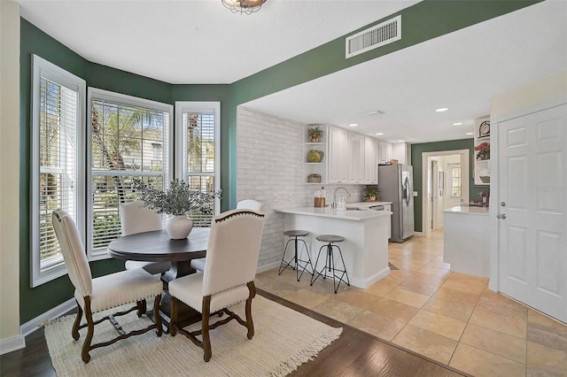 dining space featuring light tile patterned floors, recessed lighting, visible vents, and baseboards