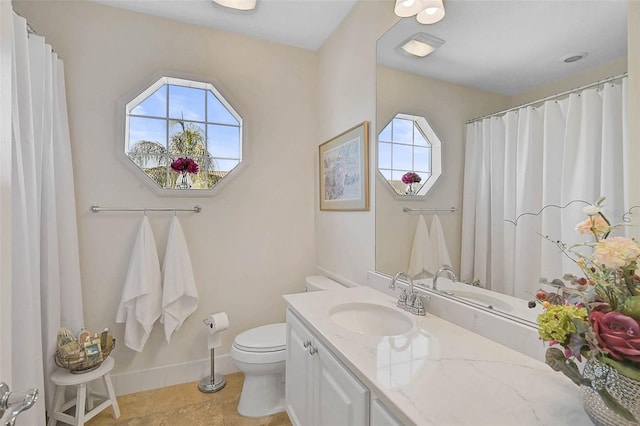 full bath featuring toilet, tile patterned floors, baseboards, and vanity