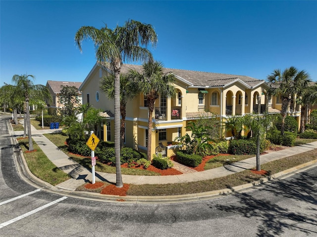 view of front of home featuring a tile roof and stucco siding