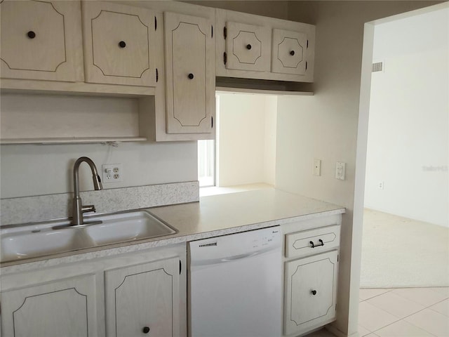 kitchen featuring light countertops, white dishwasher, and a sink