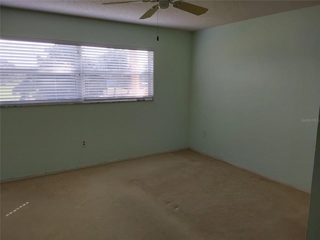 spare room with ceiling fan and a textured ceiling