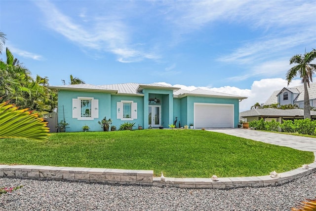 view of front of house with a garage, driveway, a front lawn, and stucco siding