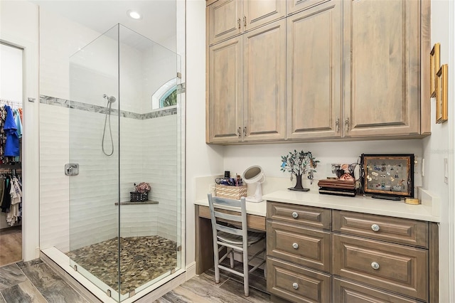 full bathroom featuring a spacious closet and a tile shower