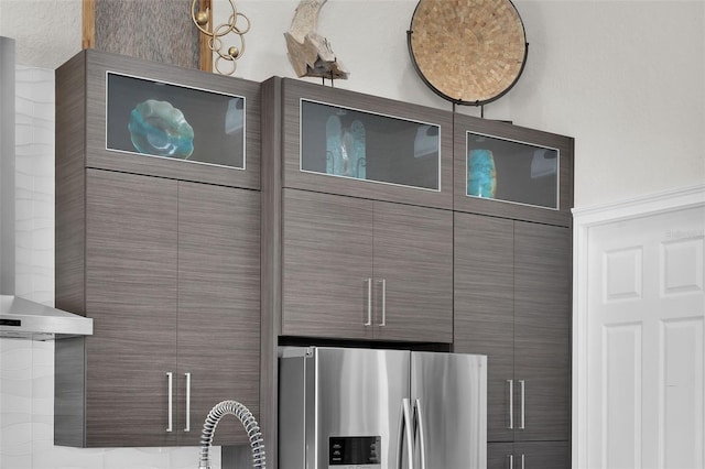 room details with light countertops and stainless steel fridge with ice dispenser