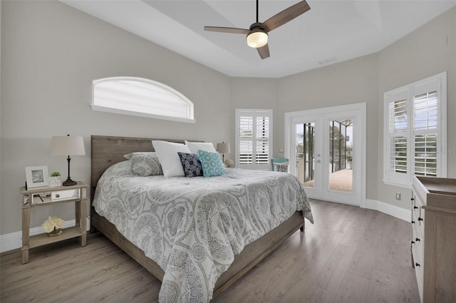 bedroom featuring french doors, visible vents, wood finished floors, access to outside, and baseboards