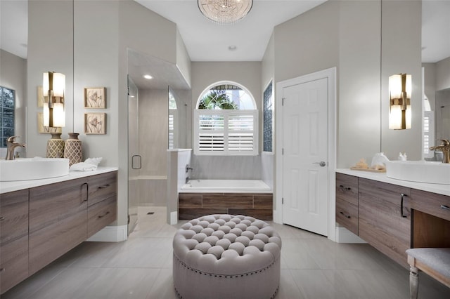 full bathroom with a stall shower, a sink, and tile patterned floors