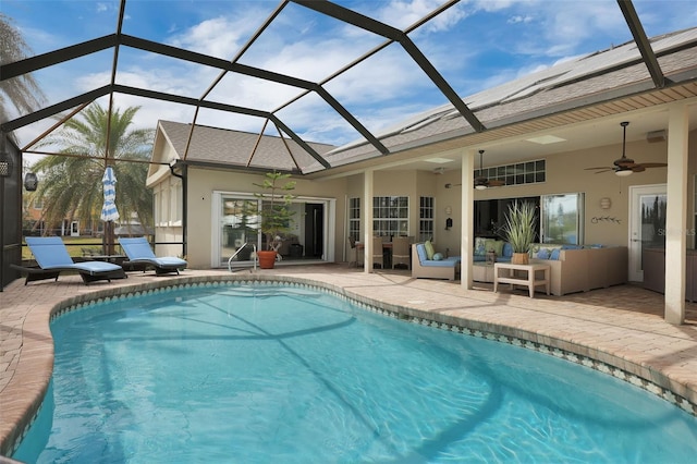 pool featuring glass enclosure, a patio area, an outdoor living space, and a ceiling fan