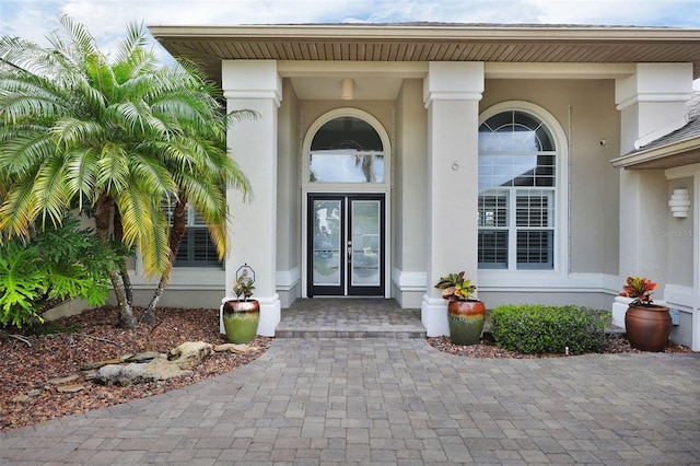 property entrance featuring french doors and stucco siding