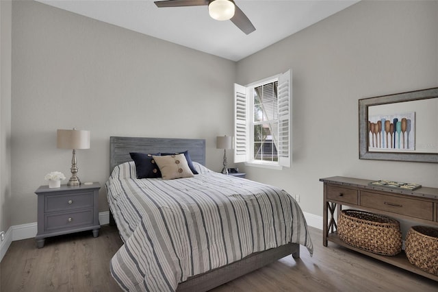 bedroom featuring a ceiling fan, baseboards, and wood finished floors