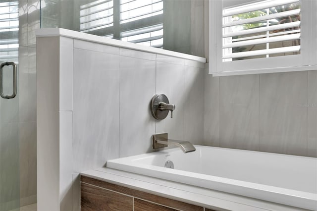 full bathroom featuring a bathtub and an enclosed shower